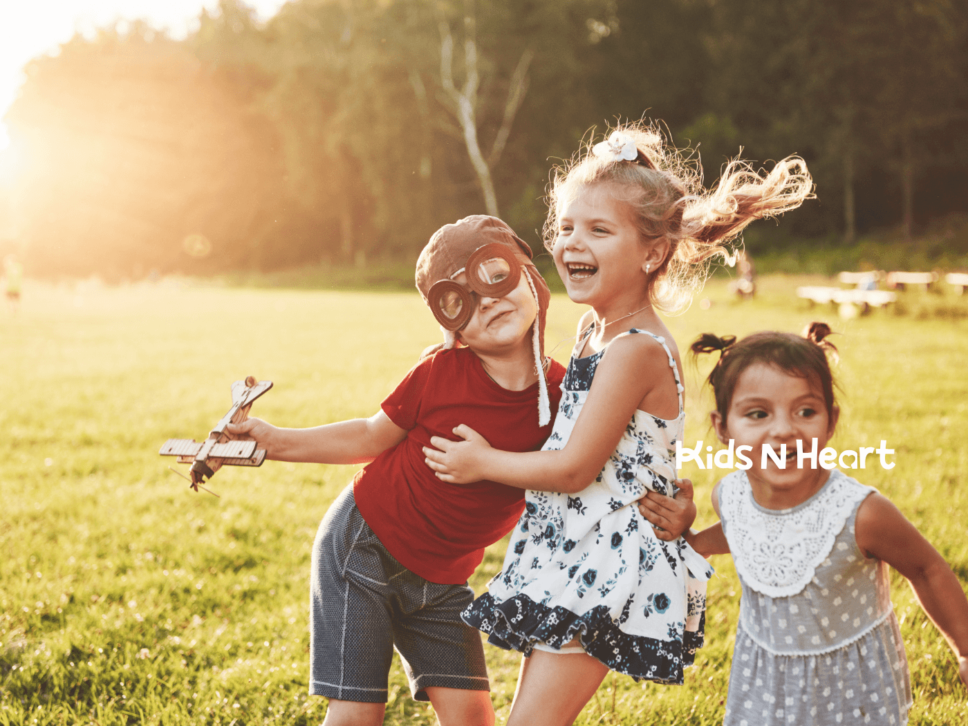 Children laughing and playing together outdoors, showing joy, friendship, and positive social interaction during free play.