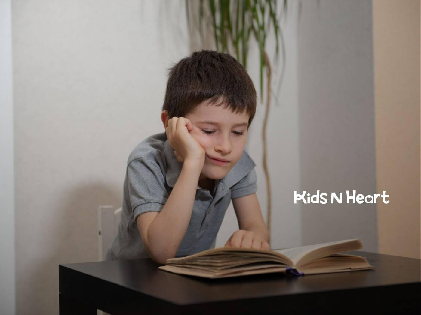 A boy with autism struggling to focus on reading at a table.