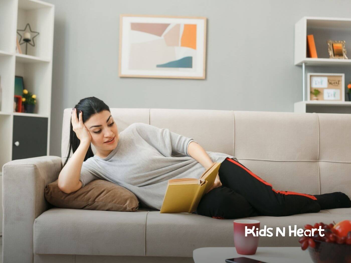 Woman with autism reading a book while relaxing on a sofa.