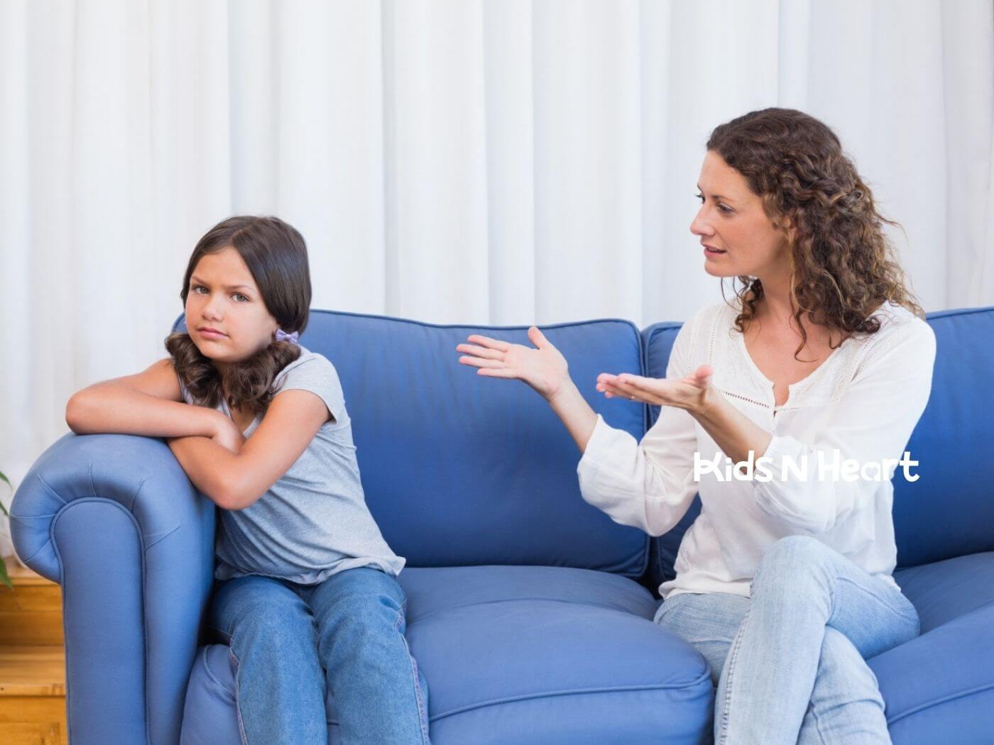 Young girl with autism ignoring ABA therapist next to her.