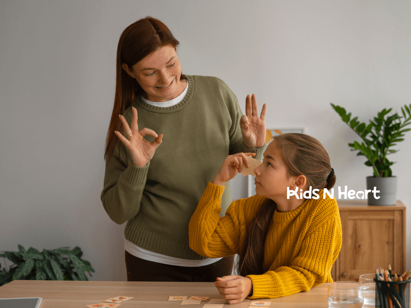 A female ABA therapist and autistic girl enjoying an educational moment, where the therapist is teaching the autistic child.