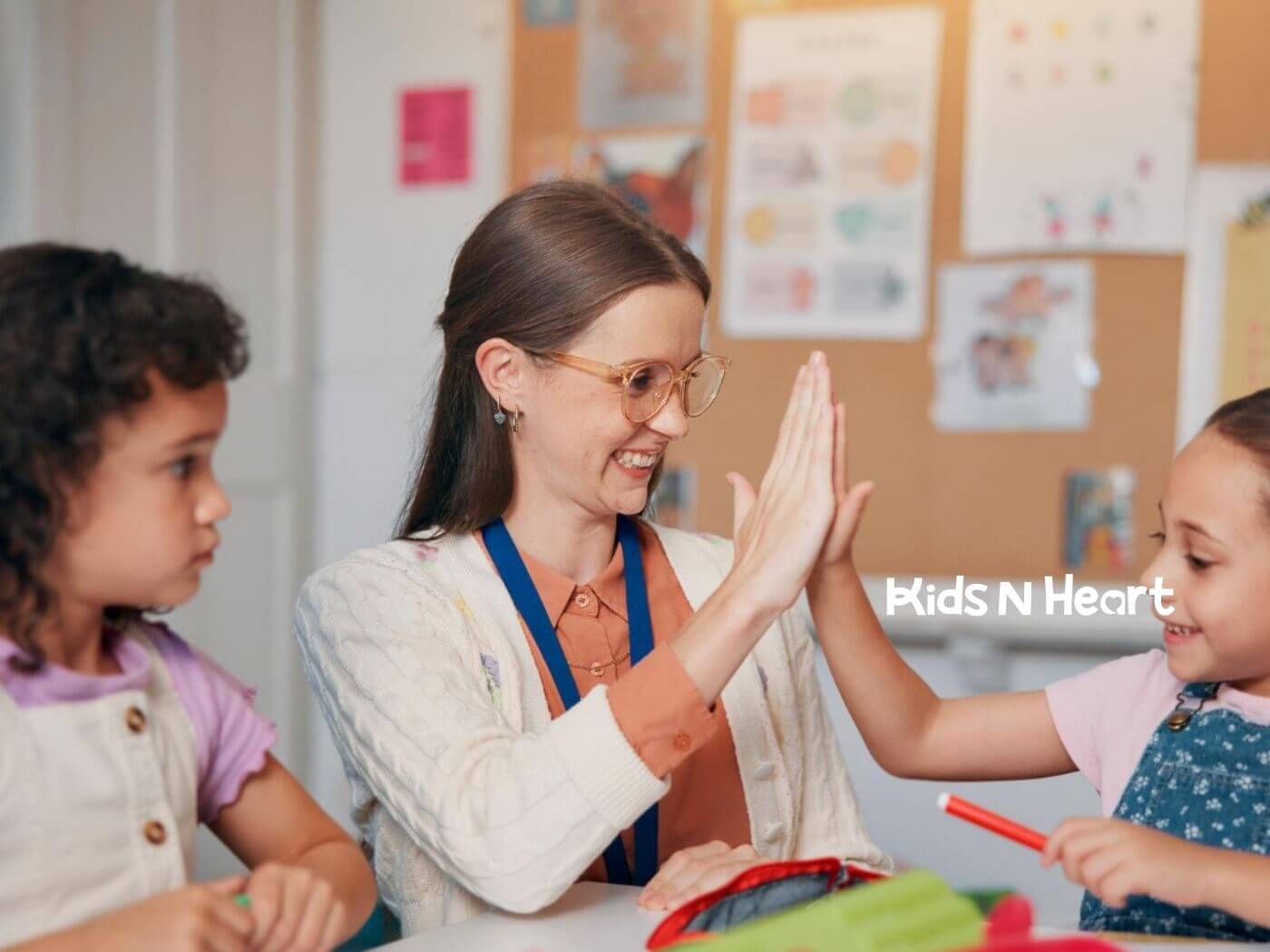 ABA therapist giving a high-five to a child during an ABA therapy learning activity.