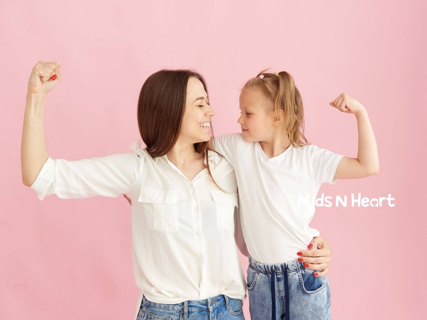 BCBA and child smiling and flexing their arms together against a pink background in ABA therapy.