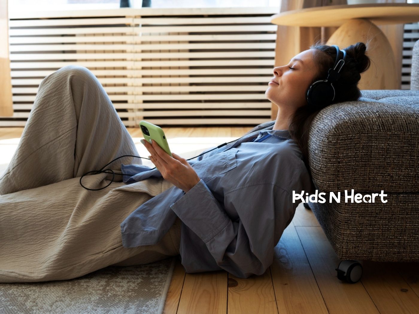 Adult with autism relaxing on the floor with headphones.