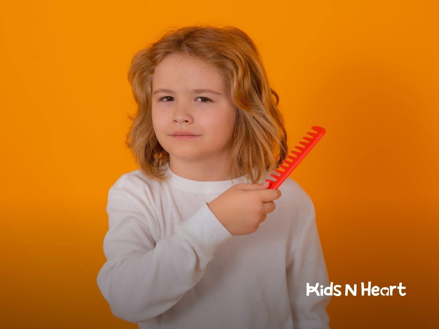 Child with autism holding a comb, looking thoughtful.