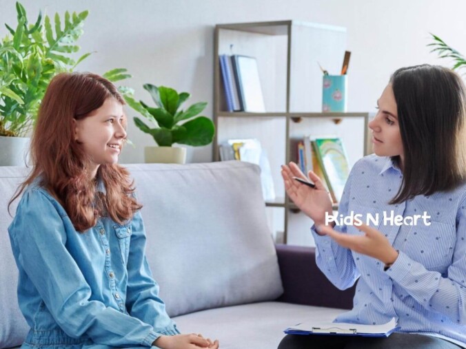 A BCBA talking with a teenage girl on a couch during a session.