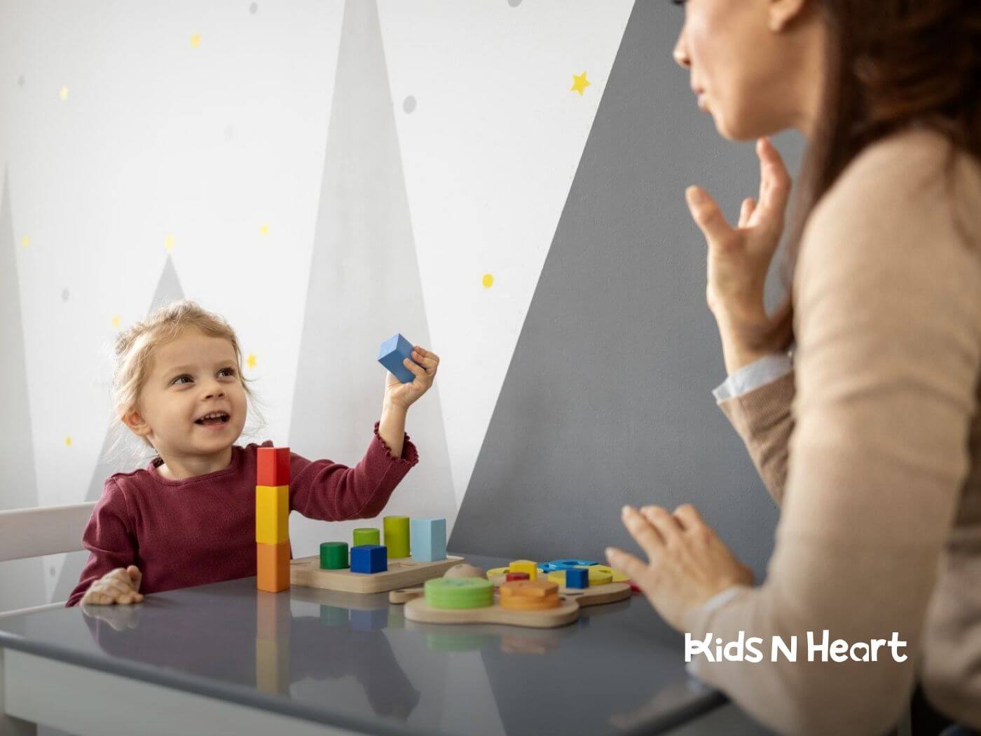 Child stacking colorful blocks while interacting with an ABA therapist in NC.