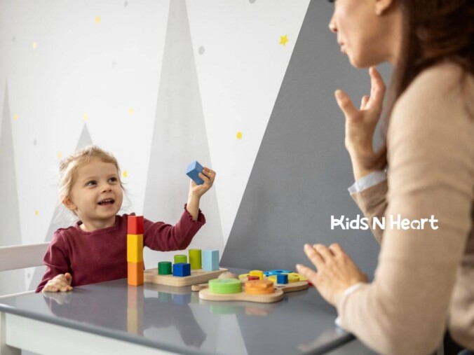 Child stacking colorful blocks while interacting with an ABA therapist in NC.