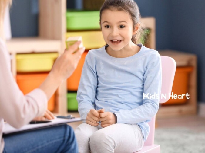 Child smiling and responding to an adult during a therapy session.