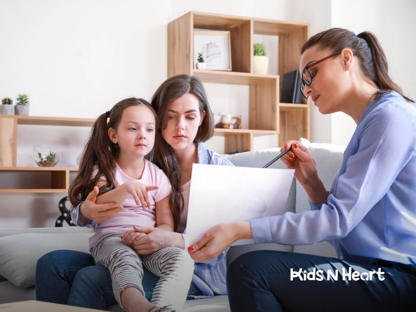 Parent helping autistic child with homework at home.